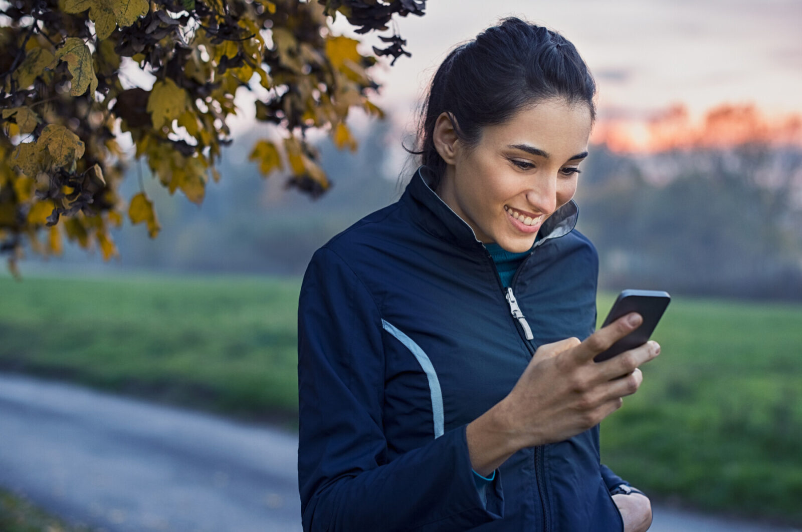 Sporty woman using phone